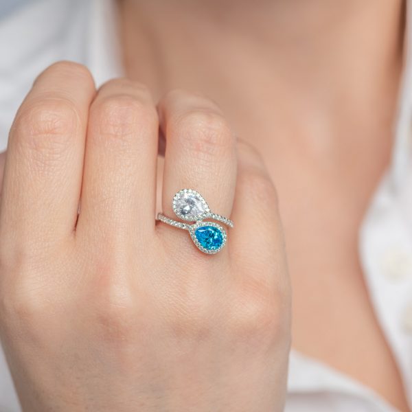Silver ring two pear rosette stones of white and blue topaz colored zirconia
