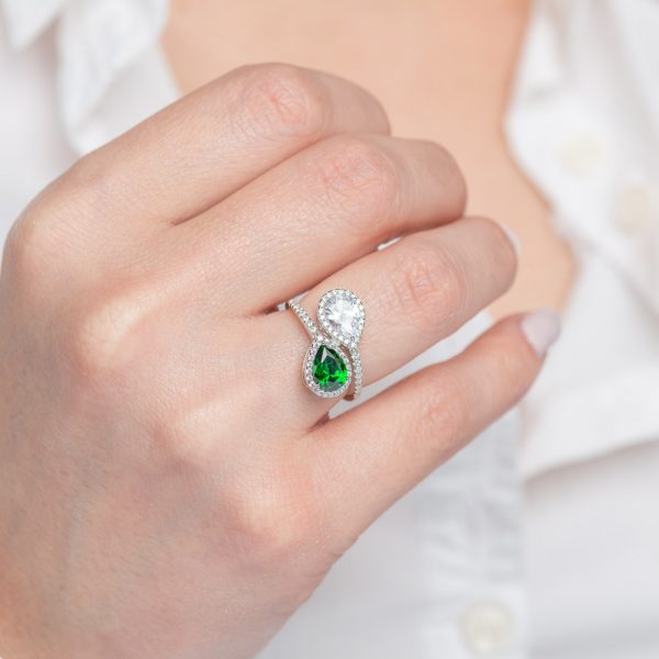 Silver ring with two pear rosette stones of white and emerald colored zirconia