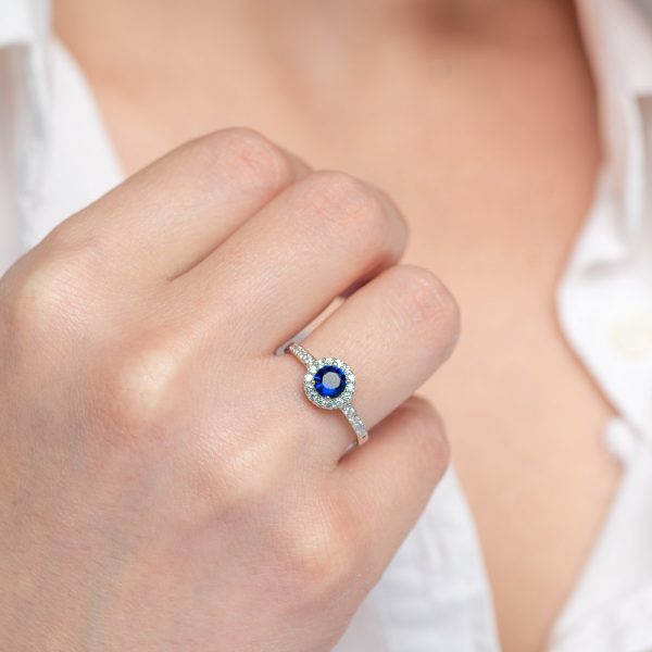 Silver ring with a central round stone of sapphire colored zirconia