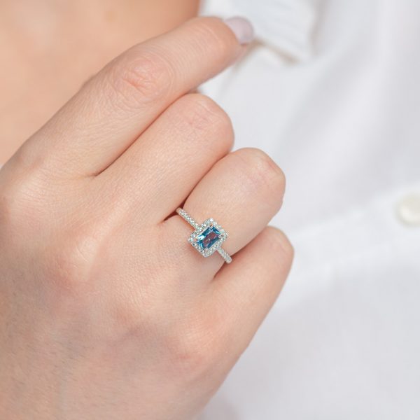 Silver ring with a central radiant round stone of london blue topaz colored zirconia