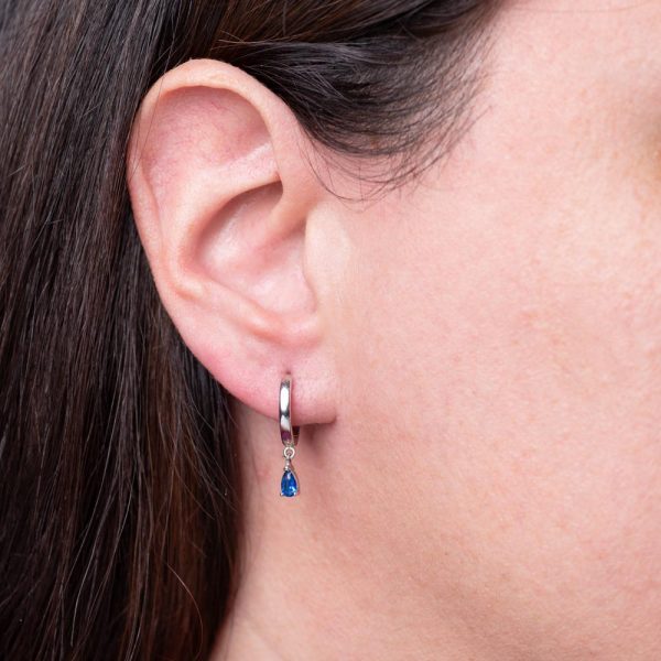Silver hoop earing with drop sapphire colored solitaire